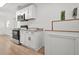 Modern kitchen featuring white cabinets, stainless steel appliances, and granite countertops at 6802 Ida St, Lithonia, GA 30058