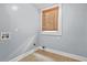 Bright laundry room with hardwood floors and lots of natural light from window at 6802 Ida St, Lithonia, GA 30058
