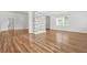 Spacious living area featuring stylish hardwood floors and a stone-clad feature wall at 6802 Ida St, Lithonia, GA 30058