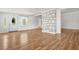 Bright open-concept living room featuring hardwood floors and a decorative stone column at 6802 Ida St, Lithonia, GA 30058