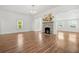 Cozy living room showcasing a stone fireplace, hardwood floors, and lots of natural light at 6802 Ida St, Lithonia, GA 30058
