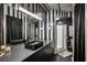 Chic bathroom with bold stripes featuring a long vanity, modern fixtures, and a glass enclosed shower at 800 Peachtree Ne St # 1014, Atlanta, GA 30308