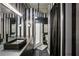 Striking bathroom with black and white stripes featuring a long vanity with dual sinks and a glass-enclosed shower at 800 Peachtree Ne St # 1014, Atlanta, GA 30308