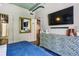 Modern bedroom with a TV features stylish furniture, including a unique decorative dresser with views to an ensuite at 800 Peachtree Ne St # 1014, Atlanta, GA 30308