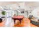 Billiards room with a red pool table, hardwood floors, leather chairs, and a flat screen television at 800 Peachtree Ne St # 1014, Atlanta, GA 30308