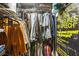 Organized walk-in closet with hanging clothes and shelves, offering ample storage space and a stylish poster at 800 Peachtree Ne St # 1014, Atlanta, GA 30308
