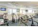 Well-equipped gym with treadmills, elliptical machines, ceiling fans, and wall-mounted televisions at 800 Peachtree Ne St # 1014, Atlanta, GA 30308