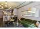 Spacious living room with open floor plan features an exposed concrete ceiling, stylish furniture, and a modern kitchen at 800 Peachtree Ne St # 1014, Atlanta, GA 30308