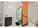 Modern bathroom with sleek vanity, white tile shower with glass door and stylish geometric tile flooring at 999 Smith Sw St, Atlanta, GA 30310