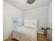 Cozy bedroom featuring a unique accent wall, plush bedding and ample natural light at 999 Smith Sw St, Atlanta, GA 30310