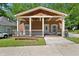 Charming home with a welcoming front porch, complete with porch swing and stylish railings at 999 Smith Sw St, Atlanta, GA 30310
