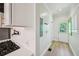 Bright kitchen featuring white cabinets, gas range, modern backsplash, and wood-look floors at 999 Smith Sw St, Atlanta, GA 30310