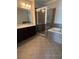 Bathroom featuring a glass shower, soaking tub, and vanity with granite countertop at 261 Cole Ne St, Marietta, GA 30060