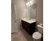 Bathroom features tile flooring, a white vanity, and an elongated commode at 261 Cole Ne St, Marietta, GA 30060