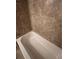 Close-up of a bathtub with tiled walls at 261 Cole Ne St, Marietta, GA 30060
