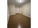 Spacious bedroom with hardwood floors, a light fixture, and a double-door closet at 261 Cole Ne St, Marietta, GA 30060
