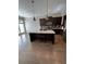 Spacious kitchen featuring a center island, dark cabinets, and hardwood floors at 261 Cole Ne St, Marietta, GA 30060