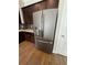 Stainless steel refrigerator in kitchen with dark wooden cabinets at 261 Cole Ne St, Marietta, GA 30060