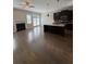 Open-concept living area with hardwood floors, fireplace, and modern kitchen at 261 Cole Ne St, Marietta, GA 30060