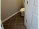 Small powder room featuring tile flooring, white trim, and a commode at 261 Cole Ne St, Marietta, GA 30060