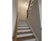 Interior shot of a staircase with wooden handrail and treads, and white risers leading to the upper level at 261 Cole Ne St, Marietta, GA 30060