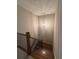 Staircase with wood treads, a decorative light fixture, and a metal railing at 261 Cole Ne St, Marietta, GA 30060