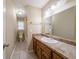 Well-lit bathroom featuring a large mirror, vanity with drawers, and ceramic tile flooring at 5310 Arrowind Nw Rd, Lilburn, GA 30047