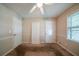 This bedroom features carpet flooring, a window, and white trim at 5310 Arrowind Nw Rd, Lilburn, GA 30047