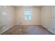 This bedroom has carpet flooring and a large window at 5310 Arrowind Nw Rd, Lilburn, GA 30047