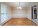 Dining room featuring hardwood floors, wainscoting, and a modern chandelier at 5310 Arrowind Nw Rd, Lilburn, GA 30047