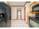 Spacious kitchen features tile floors, black appliances, and wood cabinets at 5310 Arrowind Nw Rd, Lilburn, GA 30047
