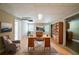 Bright home office with built in shelving, a desk, and a chair on top of wood flooring at 5310 Arrowind Nw Rd, Lilburn, GA 30047