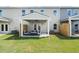 Covered patio and green lawn perfect for relaxation and outdoor entertaining at 934 Elwood St, Dacula, GA 30019