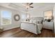 Elegant main bedroom with tray ceilings, wood floors, and bright windows at 934 Elwood St, Dacula, GA 30019