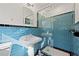 Stylish bathroom with blue tiling in shower, pedestal sink and modern fixtures at 1415 Dalewood Ne Dr, Atlanta, GA 30329