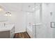 Contemporary bathroom featuring a gray vanity, white marble shower and wood floors at 1415 Dalewood Ne Dr, Atlanta, GA 30329