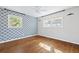 Cozy bedroom with a decorative wallpapered accent wall and two windows at 1415 Dalewood Ne Dr, Atlanta, GA 30329