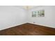 Bedroom with wood flooring, a modern light fixture, and a sunlit window at 1415 Dalewood Ne Dr, Atlanta, GA 30329