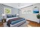 Stylish bedroom features blue accent wall, natural light, and hardwood flooring at 1415 Dalewood Ne Dr, Atlanta, GA 30329