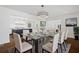 Bright dining room features modern chandelier and views of the renovated kitchen and living spaces at 1415 Dalewood Ne Dr, Atlanta, GA 30329