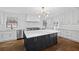 Bright kitchen boasts white cabinets, stainless steel appliances, black island, and hardwood floors at 1415 Dalewood Ne Dr, Atlanta, GA 30329