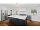 Modern kitchen featuring a large island, stainless steel appliances, and white subway tile backsplash at 1415 Dalewood Ne Dr, Atlanta, GA 30329