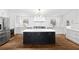 Bright kitchen boasts white cabinets, stainless steel appliances, black island, and hardwood floors at 1415 Dalewood Ne Dr, Atlanta, GA 30329
