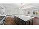 Modern kitchen island featuring a white countertop and dark cabinets with golden hardware at 1415 Dalewood Ne Dr, Atlanta, GA 30329