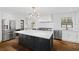 Bright kitchen boasts white cabinets, stainless steel appliances, black island, and hardwood floors at 1415 Dalewood Ne Dr, Atlanta, GA 30329