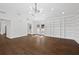 Living room with tall ceilings, modern chandelier, and large built-in bookshelves at 1415 Dalewood Ne Dr, Atlanta, GA 30329