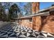 Exterior shot of the brick house featuring a black and white patterned patio at 1415 Dalewood Ne Dr, Atlanta, GA 30329