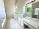 This bathroom boasts double sinks, a tub, mirrors, granite countertops, and plenty of storage space at 1805 Hunters Moon Dr, Alpharetta, GA 30005