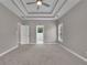 The spacious bedroom offers a view of the trees outside and the tray ceiling adds a touch of elegance at 1805 Hunters Moon Dr, Alpharetta, GA 30005