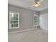 Neutral bedroom with large windows and ceiling fan at 1805 Hunters Moon Dr, Alpharetta, GA 30005
